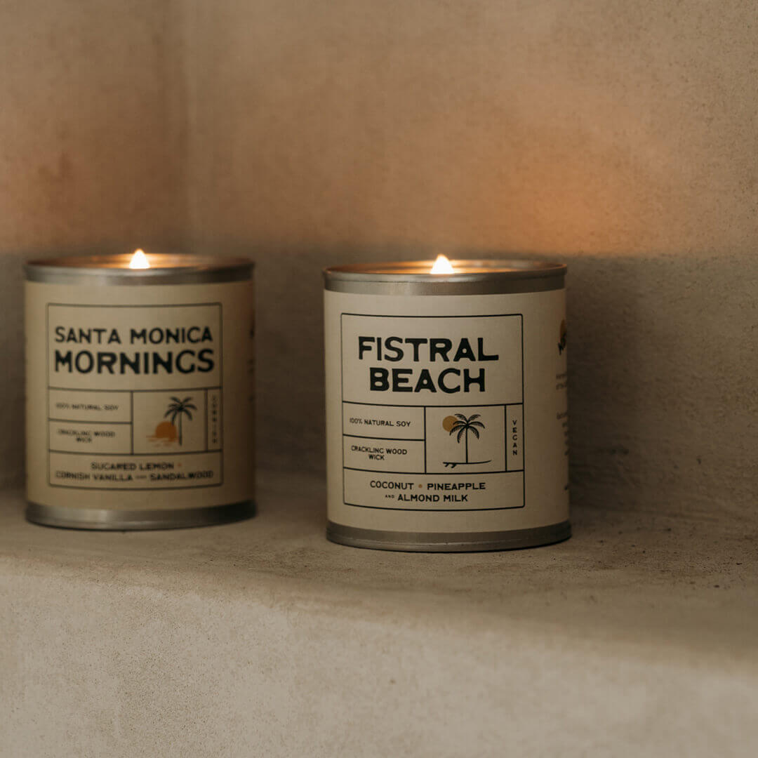 Minimalist eco-friendly scented candle made from 100% natural soy wax on a concrete shelf 'Fistral Beach' artisan soy candle with tropical coconut, pineapple, and almond milk fragrance, perfect for home decor and gifting.