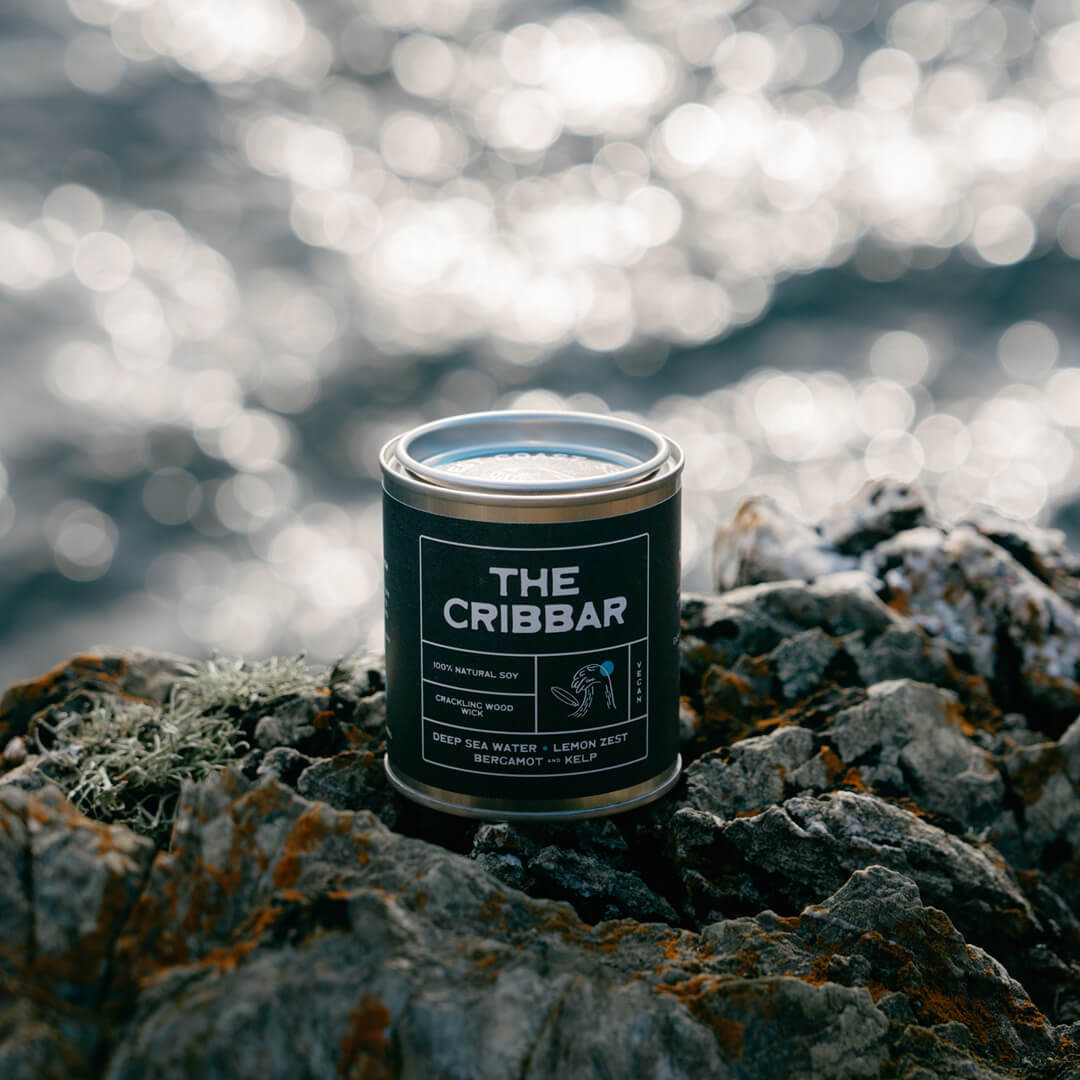 he Cribbar ocean-scented soy candle by Kernowfornia Soul, handmade in Cornwall, clean burning and eco friendly in a black tin on Newquay’s rugged coast with deep blue sea—ideal surfer-inspired gift.