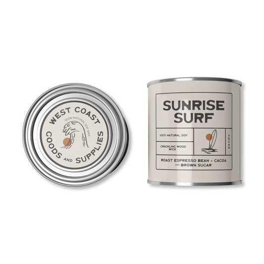 This product is a scented candle from "Kernowfornia Soul Candle Co" with a natural, minimalist design. It features the scent "Sunrise Surf" with notes of Dark Roast Pacific Espresso and Cocoa.  The tin is an off white.  Made with 100% natural soy and a crackling wood wick.