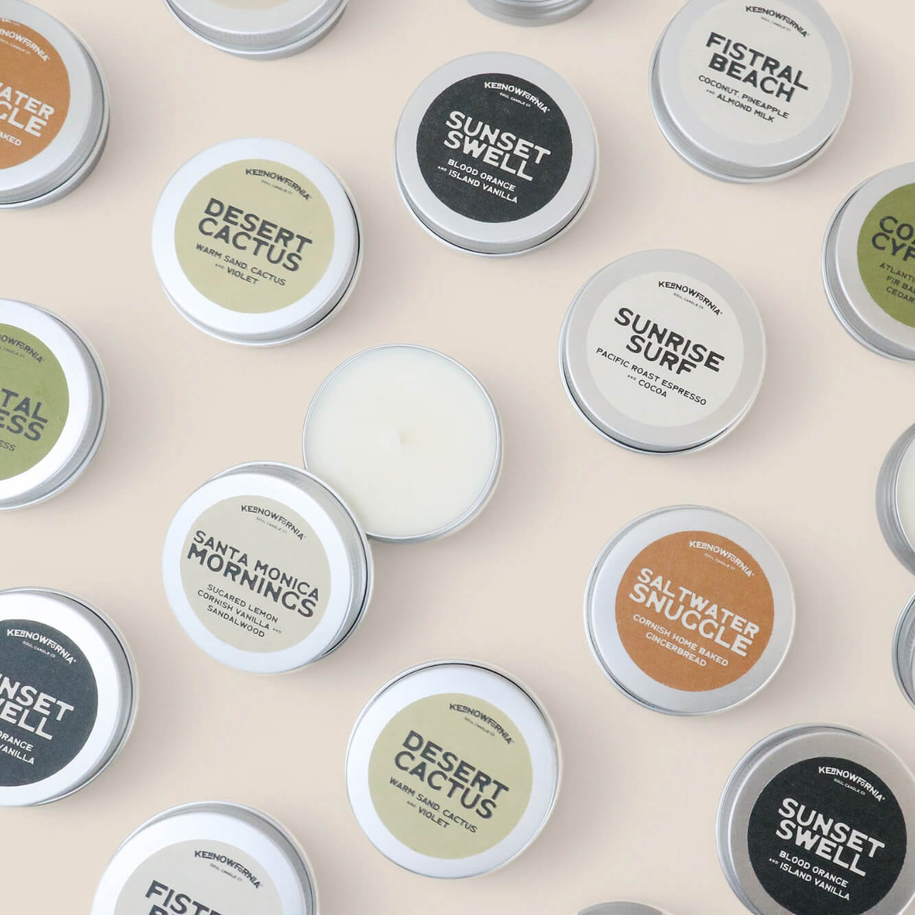 selection of small mini tea light soy candles, with kernowfornia soul branded eco labels on the lids, placed on a neutral background.  
